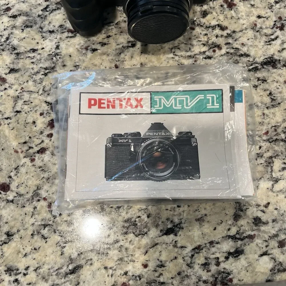 Asahi Pentax MV-1 35mm SLR Film Camera With lens, Mount, Strap and documents